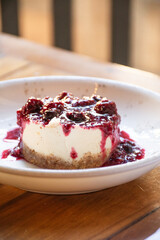 cheese cake dessert with red fruit jam on a restaurant table