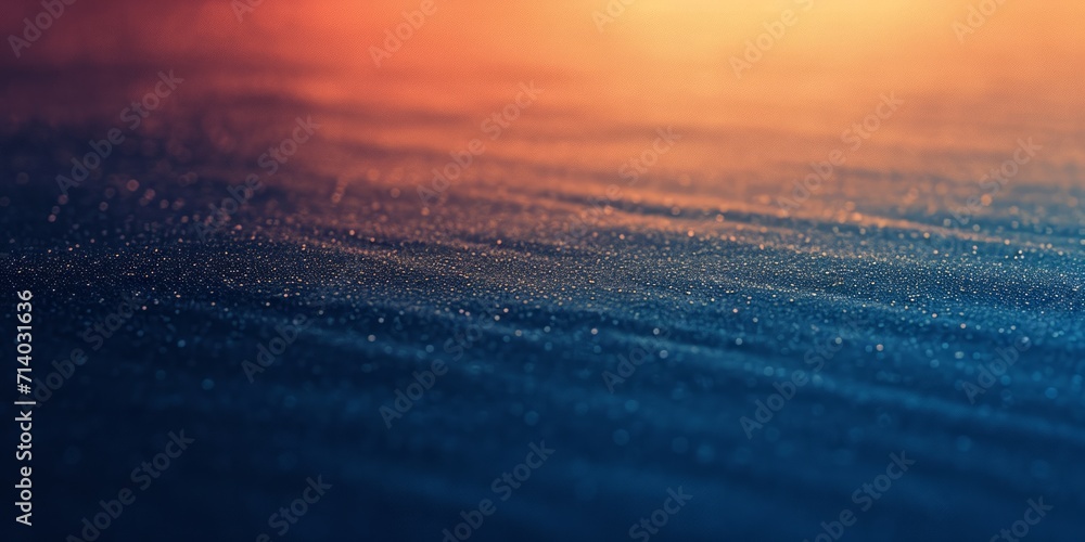 Poster close-up of a textured surface with a sparkling gradient from deep blue to warm orange.
