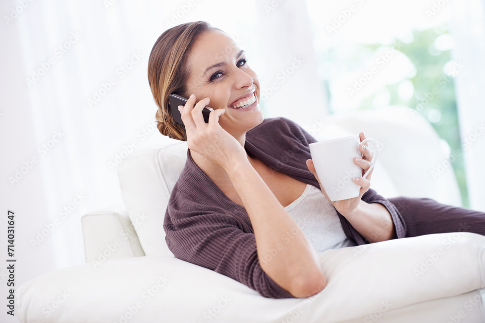 Wall mural Happy woman, phone call or relax with coffee on sofa for communication, chat or mobile network at home. Lady, smartphone or thinking of audio contact, conversation or gossip while drinking cup of tea