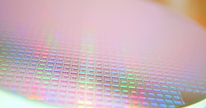 A pattern of microprocessor circuits on a silicon wafer. The semiconductors or central processing unit CPU microchips are fabricated from a silicon wafer with patterned layers of various materials.	