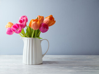 Beautiful tulip flower bouquet on white wooden table. Spring mock up for design and product display