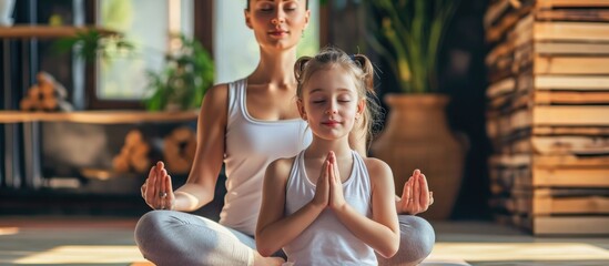 Yoga exercises performed by mother and daughter at home.