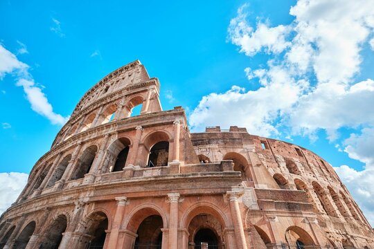 The Colosseum, Architectural wonder of Roman Empire (Colosseo) with blue sky background and clouds, Rome, Italy