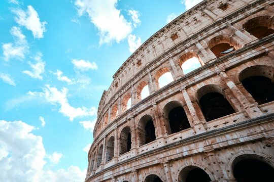 The Colosseum, Architectural wonder of Roman Empire (Colosseo) with blue sky background and clouds, Rome, Italy