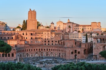 Fototapeta na wymiar The archeological ruins of Rome's historic center, named Imperial Fora and the Trajan's Market ruins at sunset, Rome, Italy