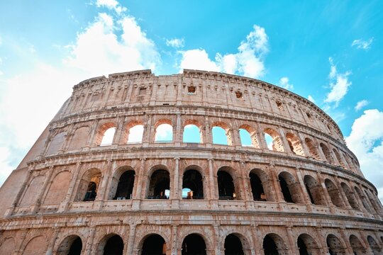 The Colosseum, Architectural wonder of Roman Empire (Colosseo) with blue sky background and clouds, Rome, Italy