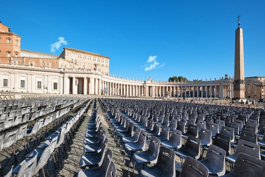 St. Peter's Basilica colonnade with rows of chairs on piazza San Pietro, Rome, Italy