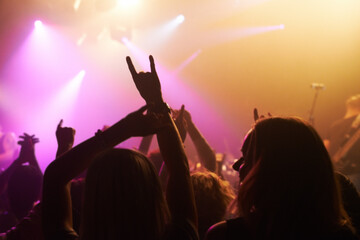 Club, concert and audience with rock or sign for music, band and rave festival with spotlight,...