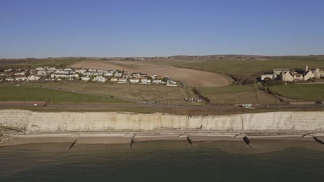 Aerial footage along the chalk cliffs near Brighton Marina with Roedean and Roedean School for girls in view.