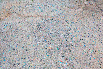 Aerial view of stack of different types of large garbage pile, plastic bags, and trash with a tractor car in industrial factory in environmental pollution. Waste disposal in dumping site.