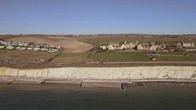 Aerial video along the chalk cliffs near Brighton Marina with Roedean School for girls in view.