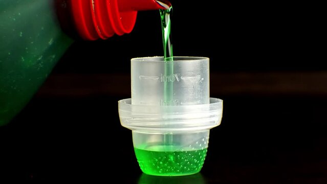 Measuring scoop used to dispense liquid laundry detergent	