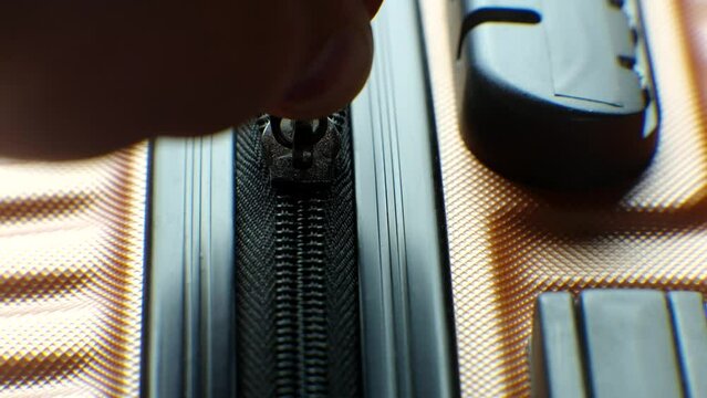 Suitcase being secured with zipper . Business trip zipping luggage