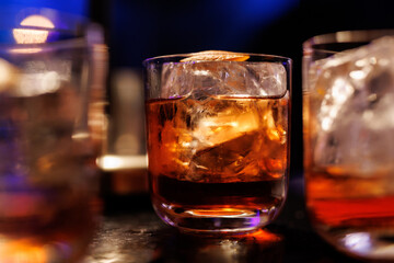 A glass of whiskey on the bar counter.