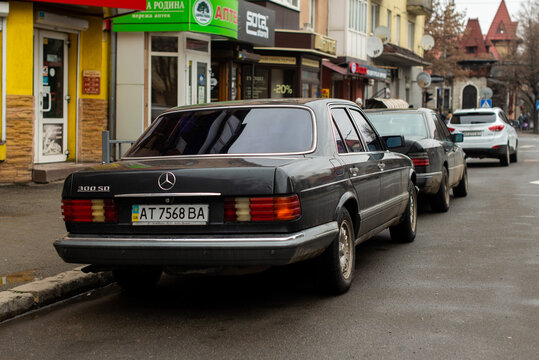 Ivano-Frankivsk, Ukraine - 19 Jan 2024: Mercedes-Benz W126 300sd, classic executive busines car of  80s, 90s, sedane car from rear and side view, vintage style. Car parking on street.	
