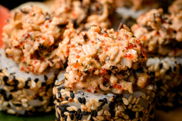 Close up of sushi set with caviar, crab, and colored sesame seeds