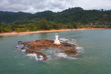 Aerial top view of lighthouse tower, Khao Lak with seawater, Andaman sea in Phang Nga Bay island in summer season, Thailand. Tourist attraction.