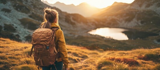 Woman finding mental wellbeing in nature during mountain hike.