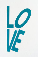 sign or header with the word "love" machine-cut from teal paper
