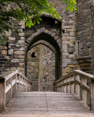 Bridge to the gatehouse and portcullis of an old stone medieval castle - Beaumaris Castle, Anglesey...