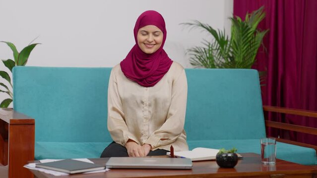 Muslim Woman in Hijab Scarf Sitting on Couch Greeting Adab