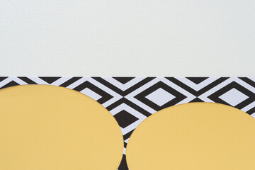 simple paper background featuring stencil frame with oval cutouts on yellow and blank paper