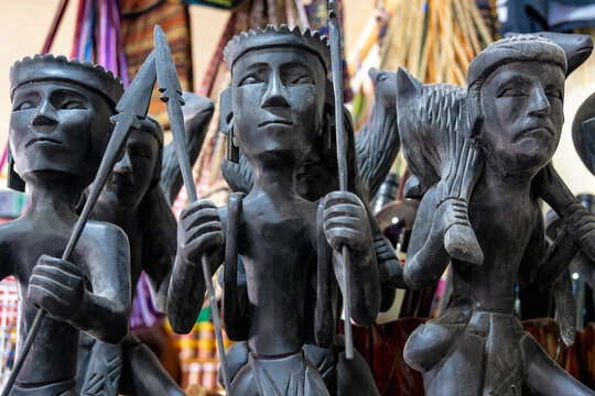 Banaue, Ifugao, Philippines - Jan 15, 2024: Traditional Ifugao wood figurines for sale at a local shop.
