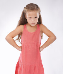 Portrait, unhappy or tantrum and girl child in studio on white background with anger and frustration. Cross, problem or moody and young kid with bad attitude looking upset at problem or mistake