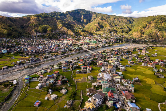 Aerial of the town of Bontoc, the capital of the landlocked province of Mountain Province, in the Cordillera Region of the Philippines. A valley town with terraced rice fields and residential areas.