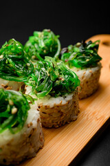 Close up of rolls adorned with chuka seaweed