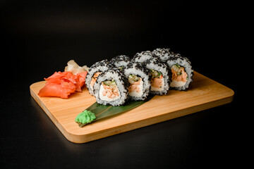 Rolls with fish and cucumber in black sesame