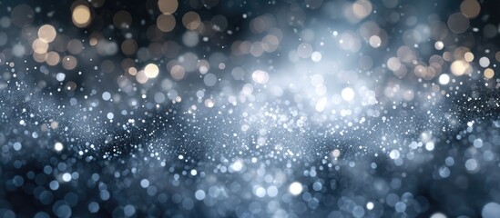Sparkling silver particles with bokeh creating an abstract background. Festive dust for Christmas...