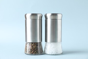 Salt and pepper shakers on light background