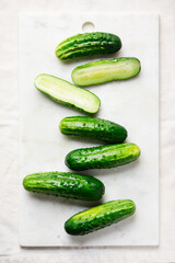 Fresh organic cucumbers on marble tray.