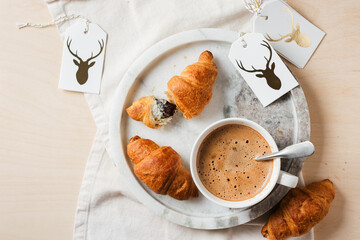 Coffee cup with chocolate croissants.