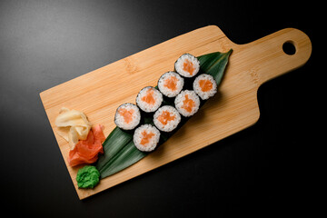 Delightful sushi display on wooden surface with condiments