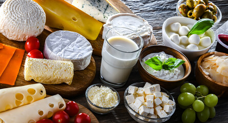 A variety of dairy products including cheese, milk and yogurt - obrazy, fototapety, plakaty