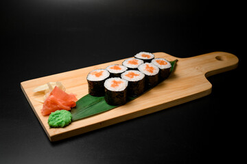 Sushi assortment with the zing of pickled ginger on wood