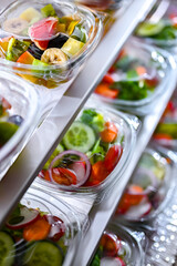 Boxes with fruit and vegetable salads in a commercial fridge