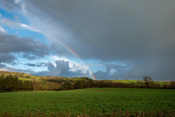 rainbow over field in rural England