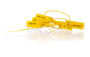 Yellow plastic security seals on a white background