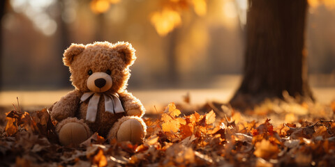 Lonely Teddy bear doll standing alone with blurry autumn forest background Lost brown bear toy looking sad International missing children's day.