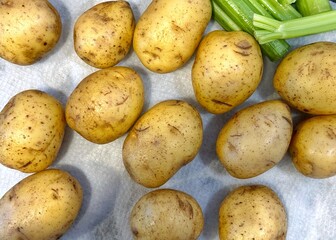 Washed yellow potatoes on white paper towel