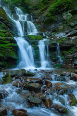 Beautiful natural waterfall. Foliage in beautiful natural waterfall. Vertical image.