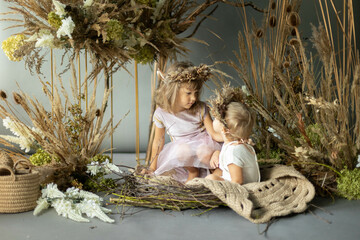 little children dressed as elves in floral decorations
