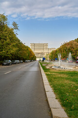 Fototapeta na wymiar Street with fountains leading up to the Palace of the Parliament in Bucharest, Romania
