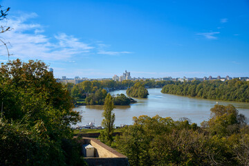Fototapeta premium Sunny autumn landscape along the Danube with trees in Belgrade, Serbia