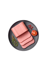 Delicious canned pink ham with salt, spices and herbs