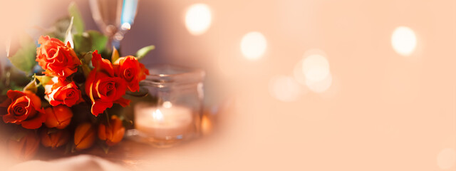 Still life with red roses and tulips on a light apricot tone with shiny bokeh. Horizontal festive...