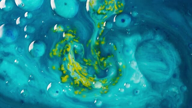 Background video of the abstract movement of the liquid flow of blue and yellow colors. Mixing of multi-colored liquids. High quality 4k footage
